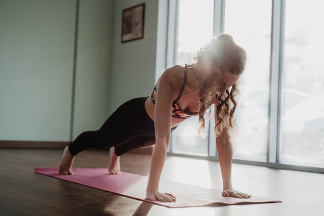 woman in plank position as part of a beginner workout, type of exercise is strength