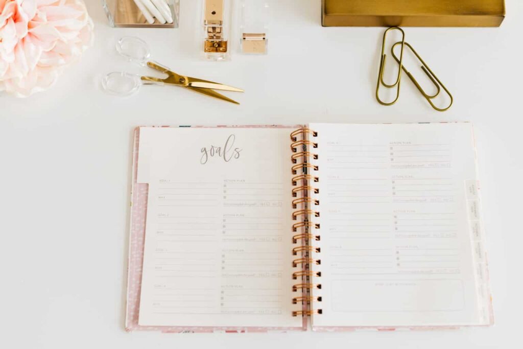 neat desk with goals planner and office supplies