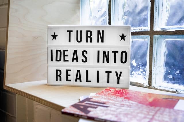 sign that reads "turn ideas into reality"