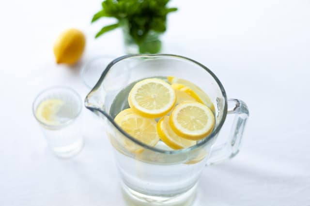 pitcher of water with lemon slices