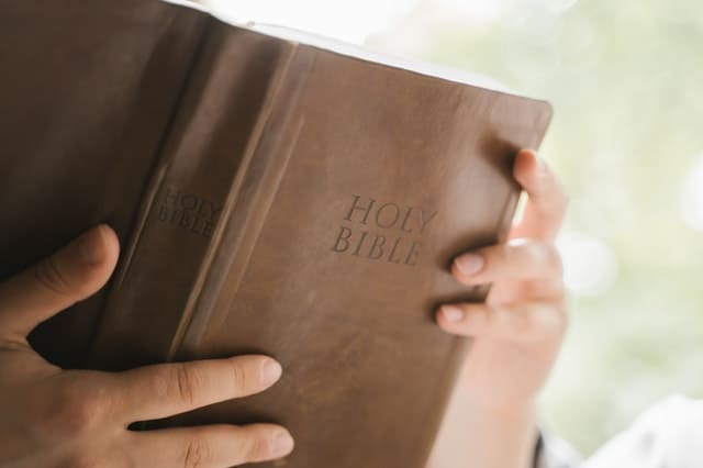 hands holding bible, a good read for reducing anxiety