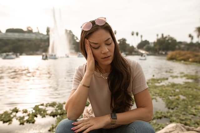 girl with hand on head