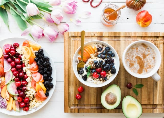 plates and bowls of healthy snacks like fruits